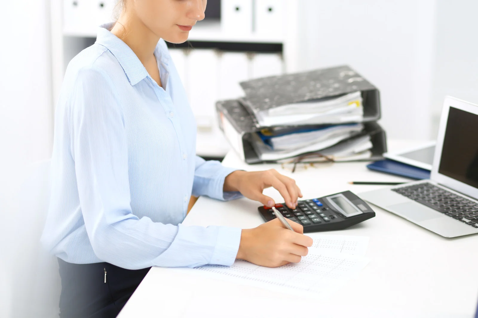 woman bookkeeper calculating and doing bookkeeping services Burnaby